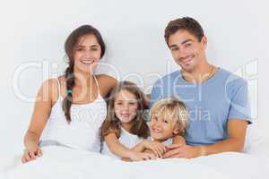 Family sitting on the bed