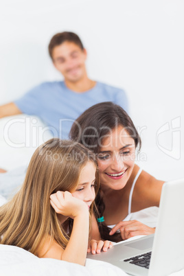 Happy family sitting with a laptop