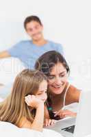 Happy family sitting with a laptop