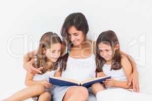 Mother and her children looking at a photo album