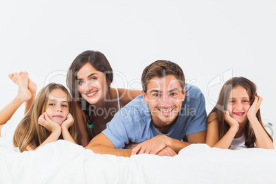 Cute family lying on a bed together