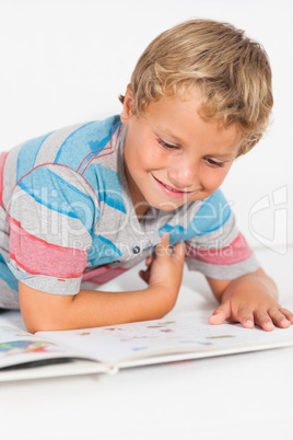 Happy boy reading a storybook