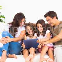 Pretty family using a digital tablet