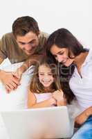 Lovely family using the laptop