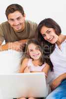 Happy family using the laptop