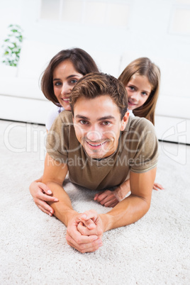 Family lying on a carpet posing