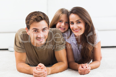 Family posing lying on a carpet