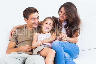 Smiling family playing together on a sofa