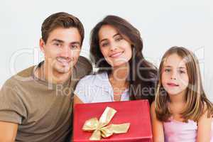 Father and his daughter offering a gift to her mother