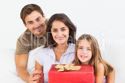 Parents offering a gift to their daughter