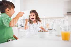 Two children eating cereal