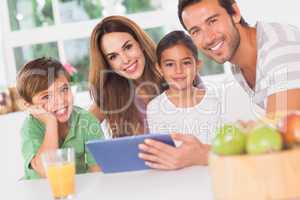 Happy family using a tablet pc