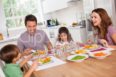 Family laughing around a good meal