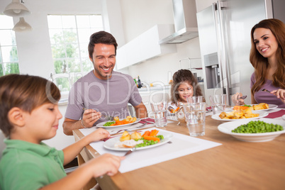 Family smiling around a good meal