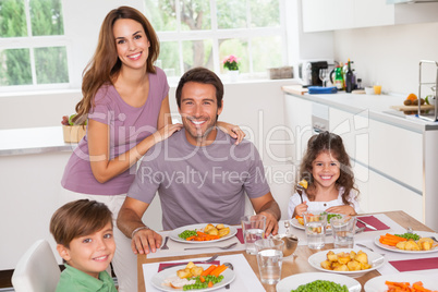 Family smiling at the dinner table