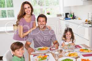 Family smiling at the dinner table