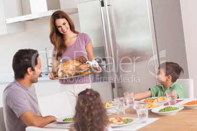 Mother carrying roast turkey for dinner