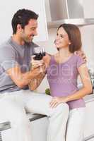 Couple toasting with arms crossed with a glass of wine