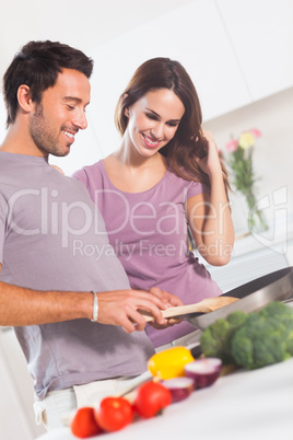 Happy couple making dinner