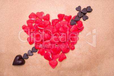 Heart and arrow shaped from candy and chocolate