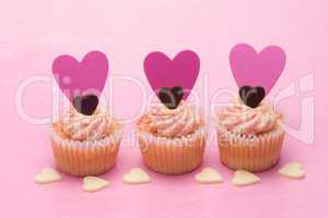 Three valentines cupcakes with heart decorations
