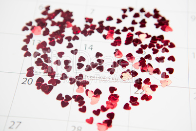 Pink confetti scattered in heart shape over valentines day