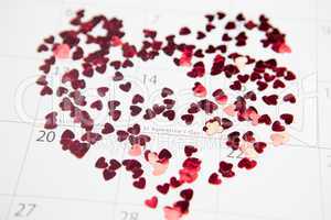 Pink confetti scattered in heart shape over valentines day
