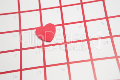 Pink heart resting on valentines day on calendar