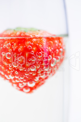 Strawberry floating in champagne