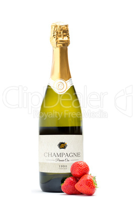 Bottle of champagne with three strawberries