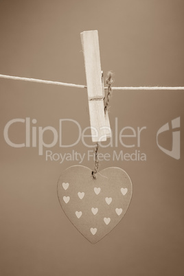 Heart ornament hanging from a peg on a line