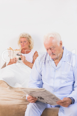 Elderly couple reading on the bed