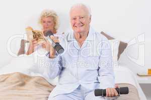 Elderly man lifting hand weights