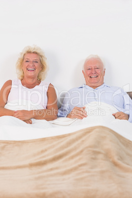 Aged couple lying on the bed