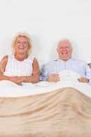 Aged couple lying on the bed