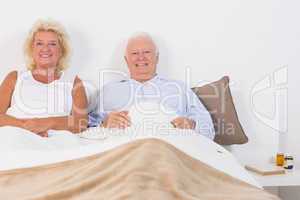 Old couple lying on the bed