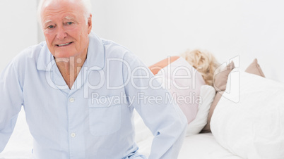 Old man sitting while woman sleeping