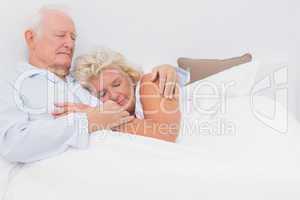 Asleep couple lying on the bed