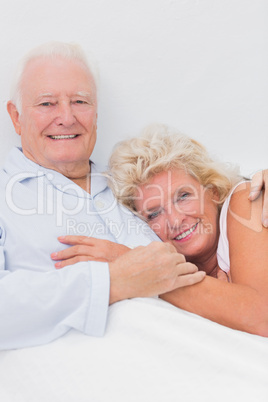 Happy couple lying on the bed