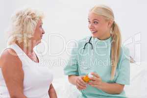 Home nurse and patient talking together about medicine