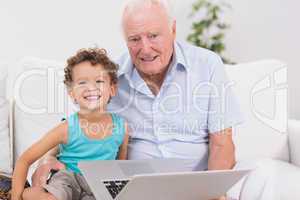 Grandfather and grandson with a laptop