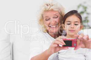 Granddaughter and grandmother taking pictures