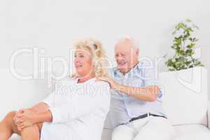 Old man massing a elderly woman