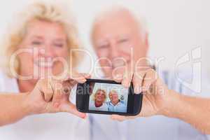 Old couple taking pictures with a smartphone