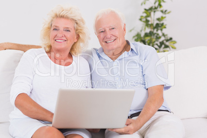 Old couple using a laptop together