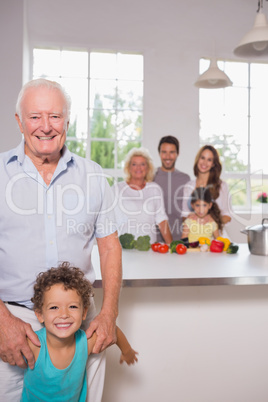 Grandfather and grandson in front of their family