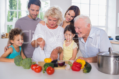 Happy family cutting vegetables together