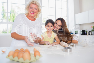 Smiling women of a family baking together