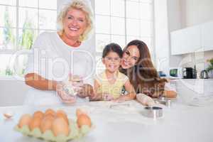 Smiling women of a family baking together