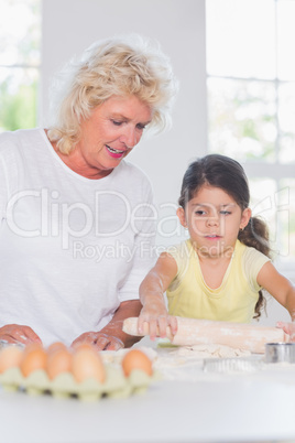 Granddaughter and grandmother baking together